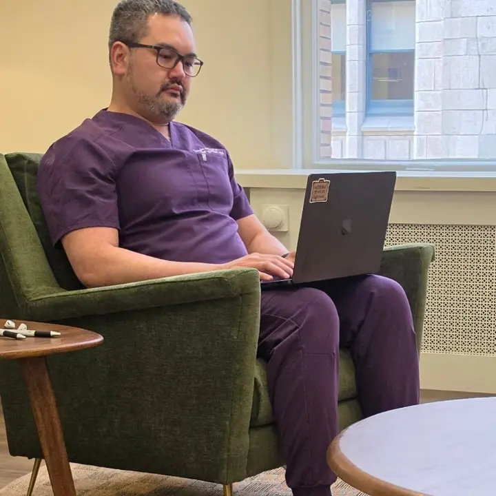 Canybec Sulayman at his laptop in the San Francisco office